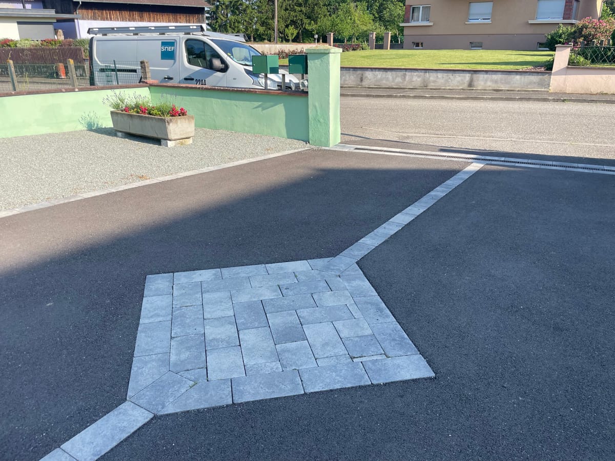 Raccord entre enrobé et pavés à la jonction avec la voirie